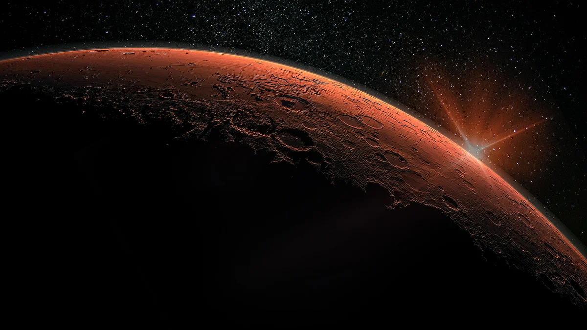 Image of Mars with its reddish surface and craters visible in space, illuminated by a distant starburst on the horizon against a backdrop of stars.