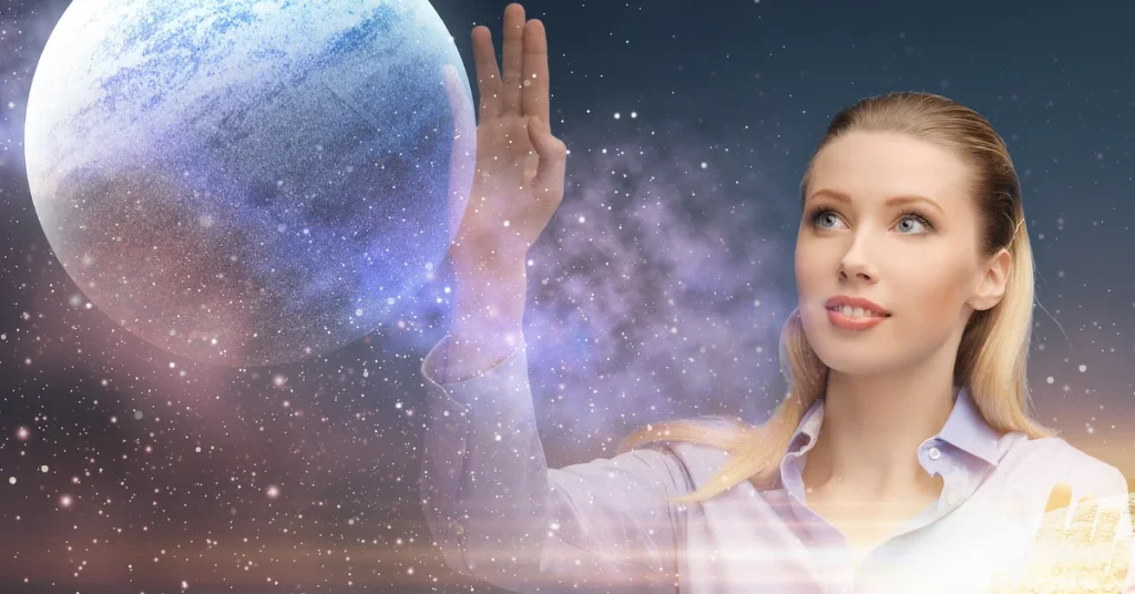 A woman with blonde hair reaches out with her hand toward a large, glowing planet in a star-filled galaxy. She is looking at the planet with a calm expression.