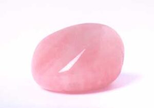 A smooth, polished rose quartz crystal with a soft pink hue, shown against a plain white background