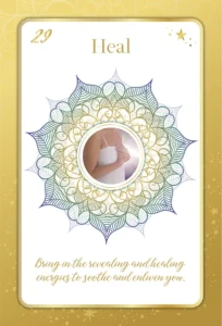 A card from Kim Woods' Intuition Oracle Deck" titled "Heal," featuring a mandala design and an image of a person holding their hands over their chest. The text at the bottom reads: "Bring in the revealing and healing energies to soothe and enliven you."