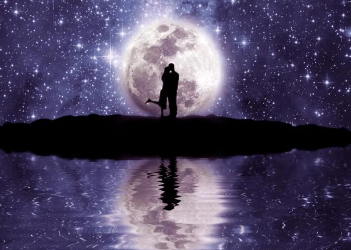 A romantic silhouette of a couple embracing under a glowing full moon, with a star-filled sky and its reflection shimmering on calm water.