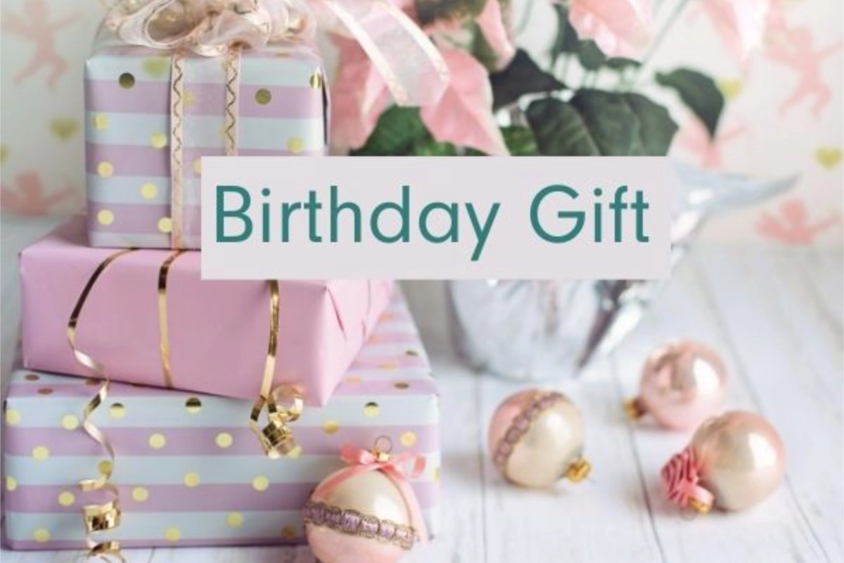 Pastel-colored birthday gifts with gold ribbon, surrounded by pink and gold holiday ornaments.